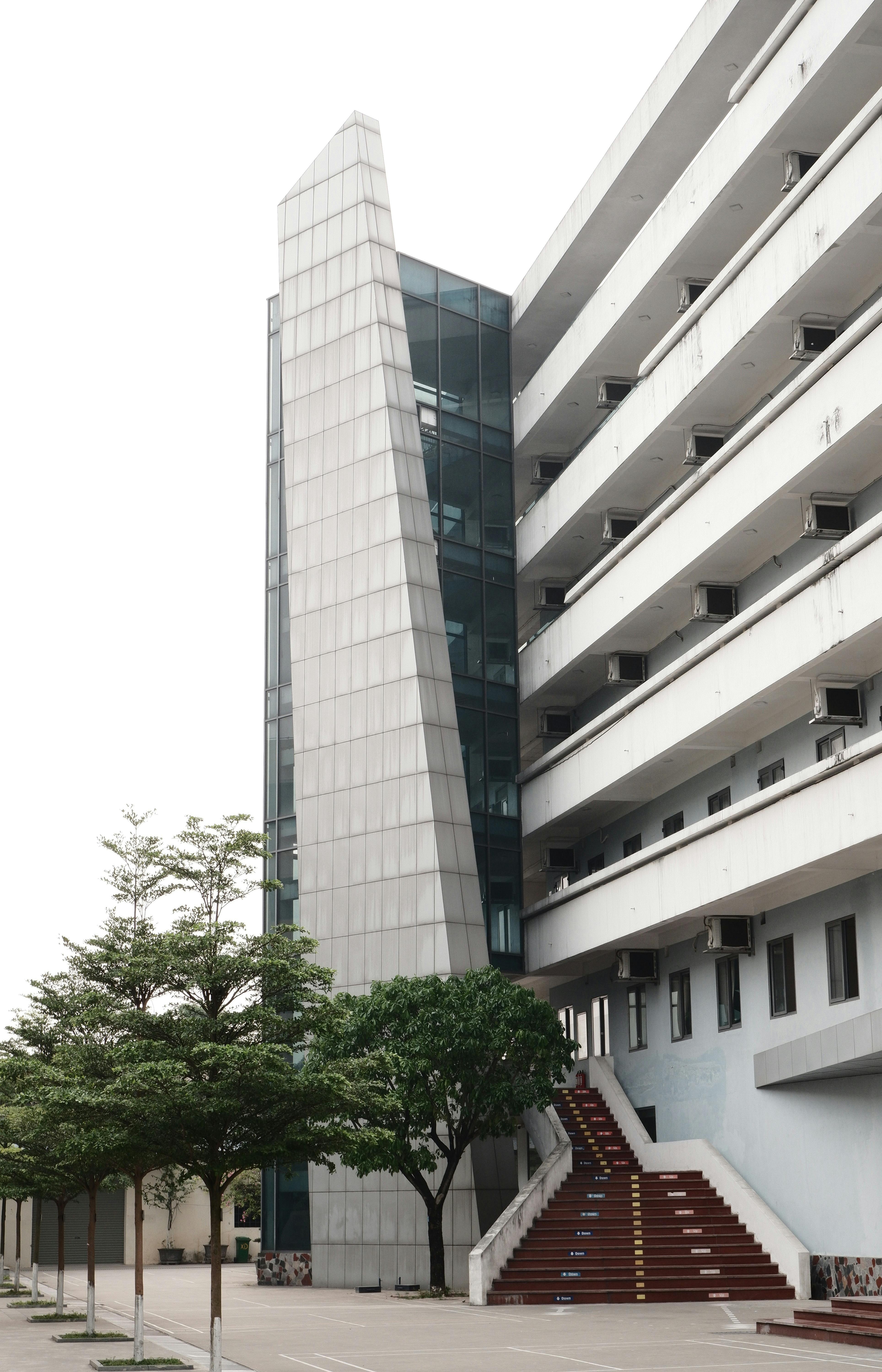 Contemporary apartment building showcasing a modern facade with external stairs in an urban setting.