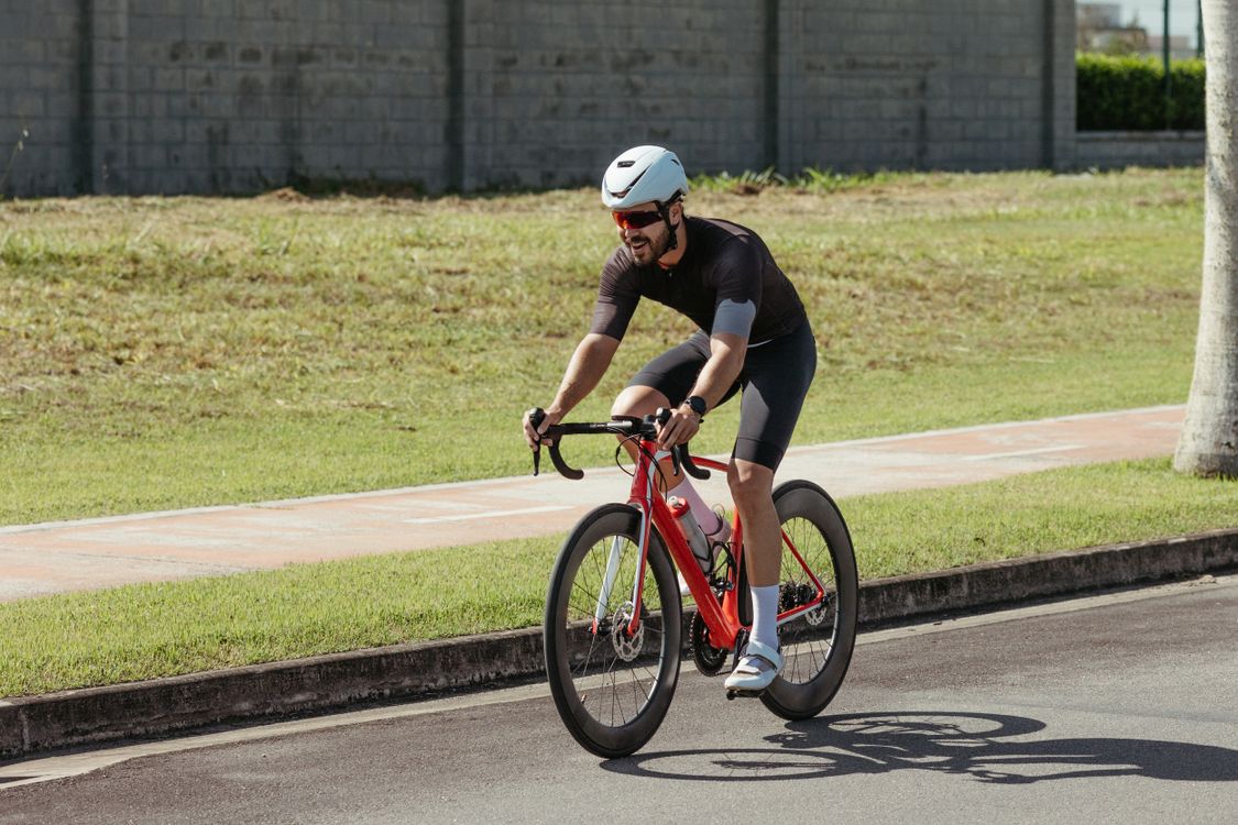 A man riding a bike on a road · Free Stock Photo