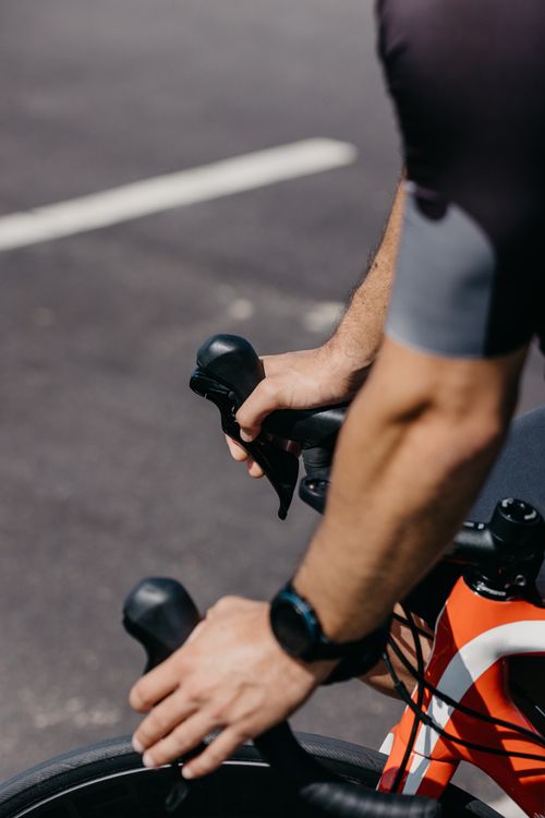 Free Detailed shot of a cyclist's hands on handlebars, emphasizing fitness and outdoor activity. Stock Photo