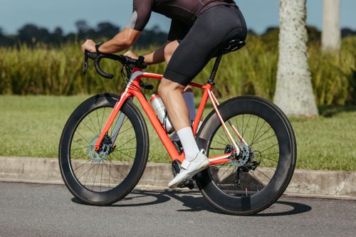 Free A cyclist riding a modern road bike on a sunny day, showcasing fitness and speed. Stock Photo