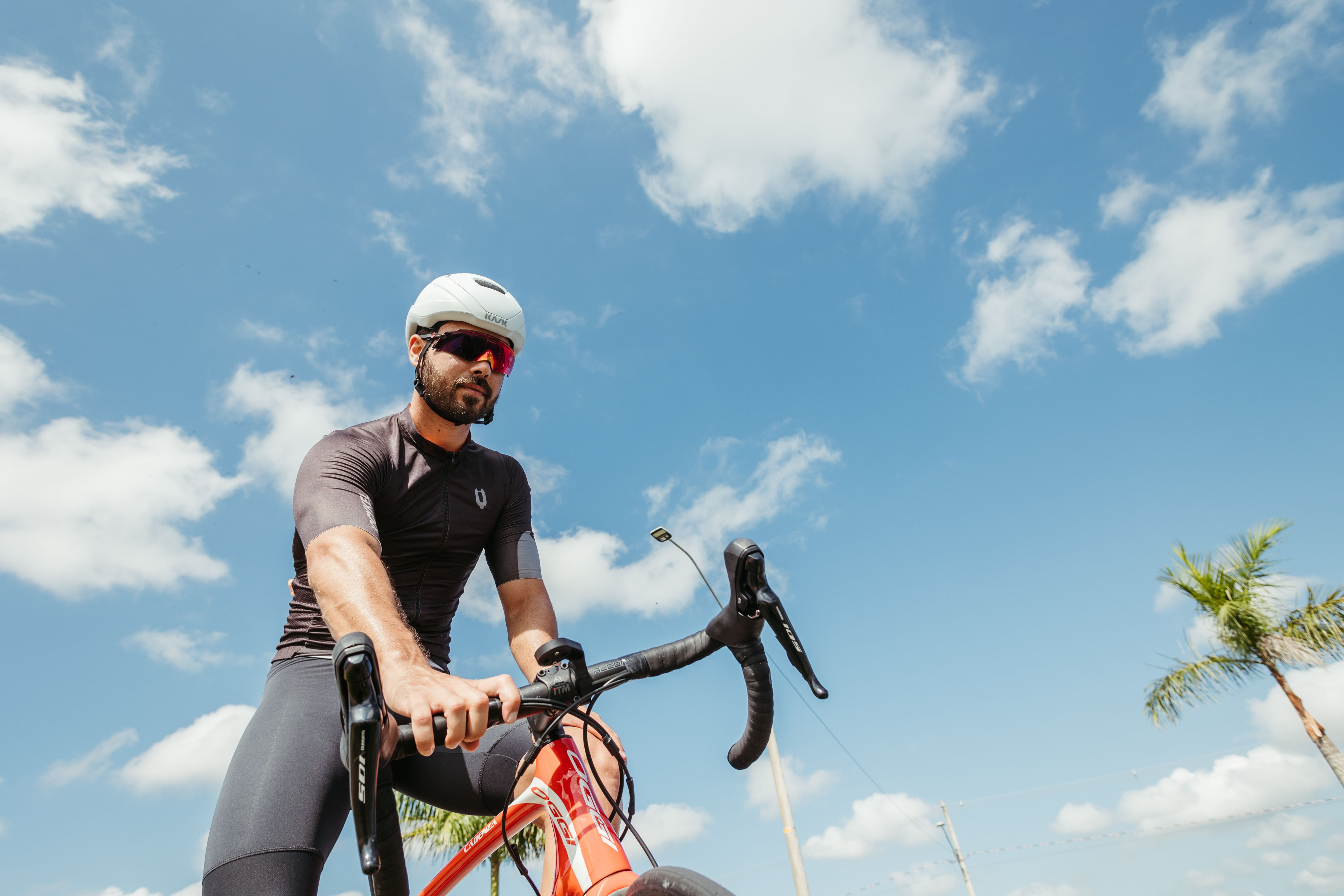 A cyclist on a sunny day, enjoying an outdoor adventure under a clear blue sky.