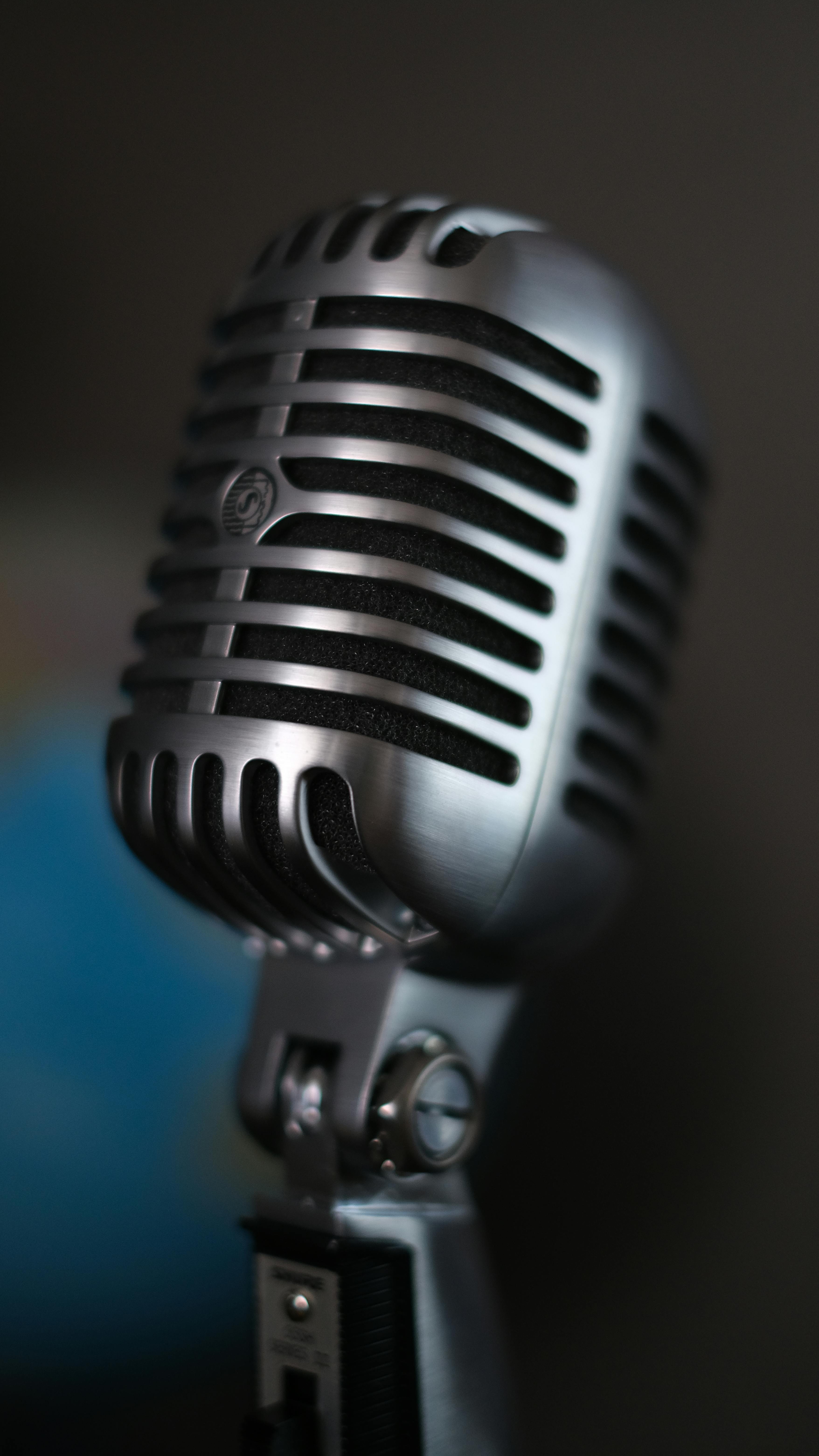 A detailed close-up of a vintage silver microphone, capturing its classic design and metal texture.