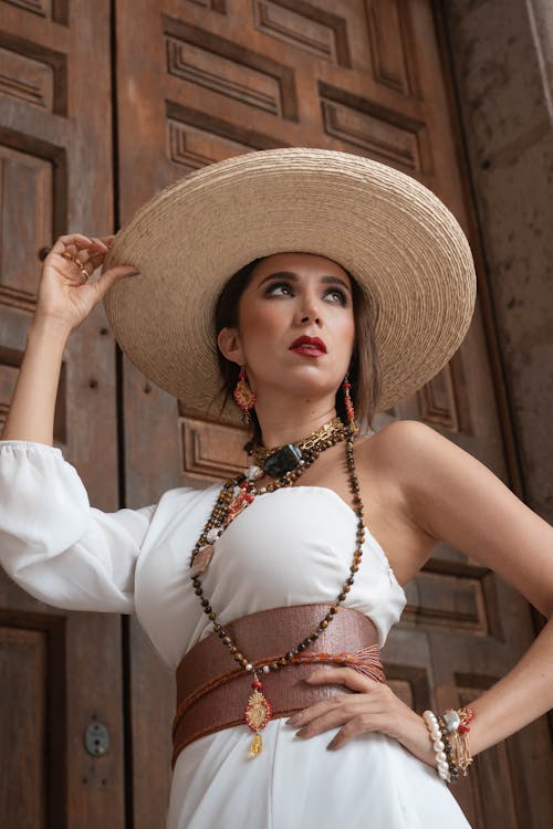 Fashionable Woman Standing in front of Wooden Door 