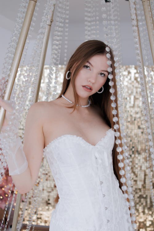 Young Woman Posing in a White Corset 
