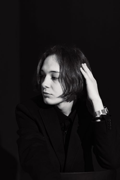Free Refined studio portrait of a young model in a blazer with a wristwatch, exhibiting elegance and style. Stock Photo