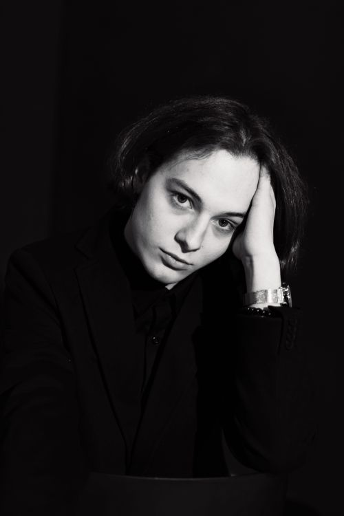 Free Black and white portrait of a model in a dark setting, exuding elegance and introspection. Stock Photo