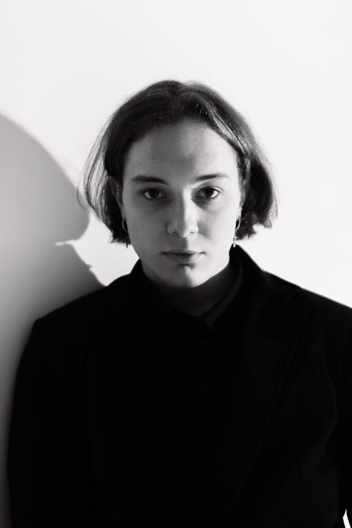 Free Elegant black and white portrait of a serious young adult in a studio setting. Stock Photo