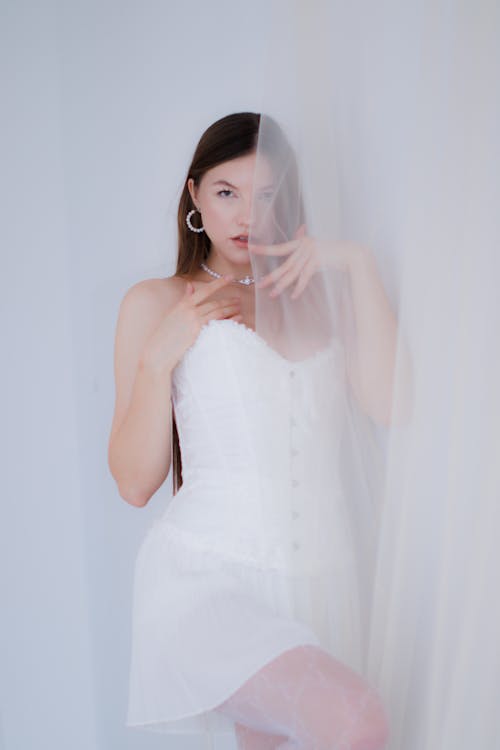 Young Woman Posing in a White Dress