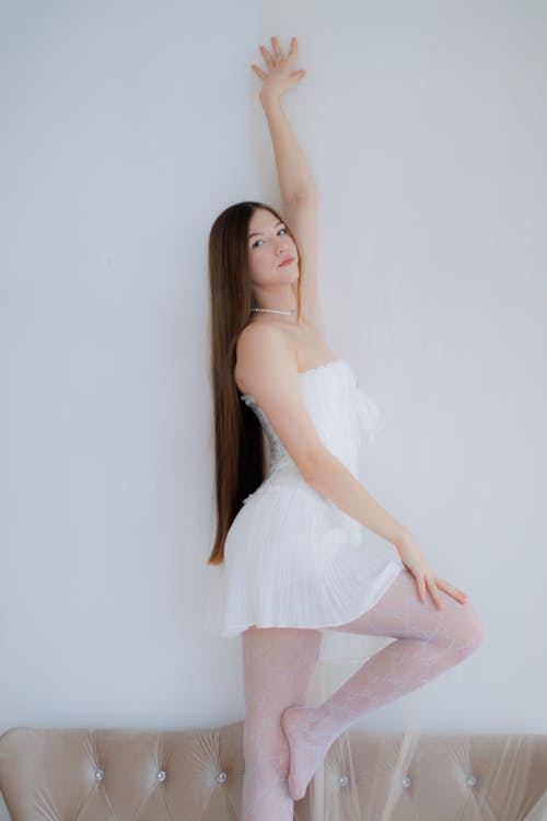 Free Young Woman Posing in a White Dress Stock Photo