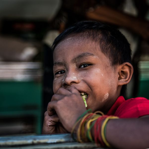 A cheerful child eating a fresh snack outdoors — photo by Christine Blanchet on Pexels