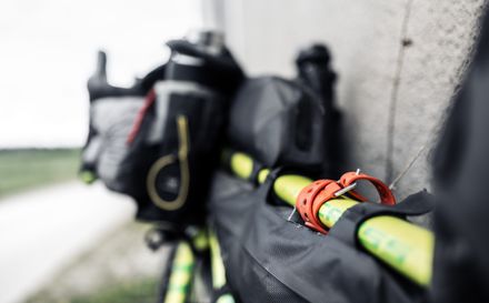 Close-up of packed bikepacking gear with an orange strap — photo by Marek Piwnicki on Pexels