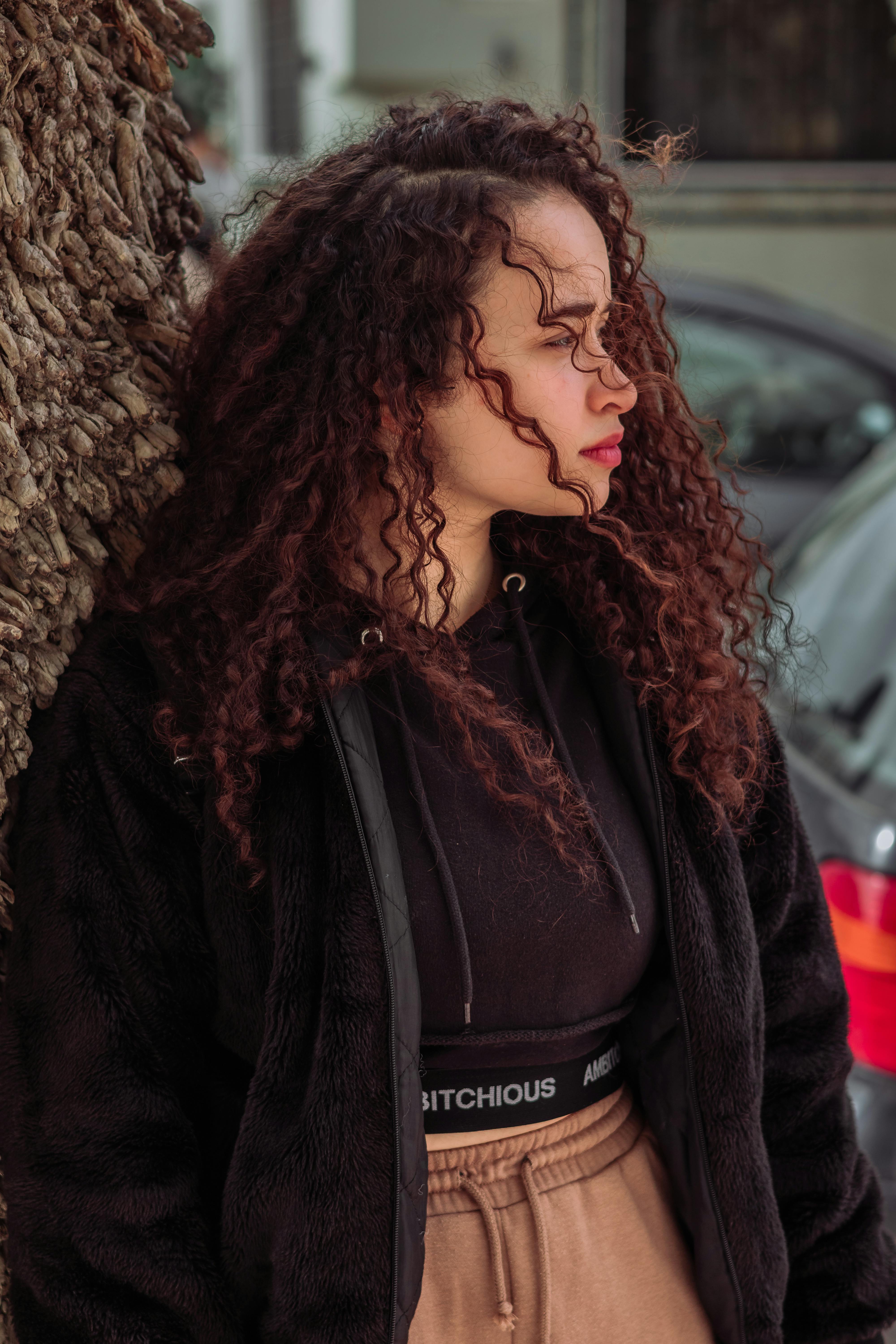 Portrait of Brunette Woman with Curly Hair · Free Stock Photo