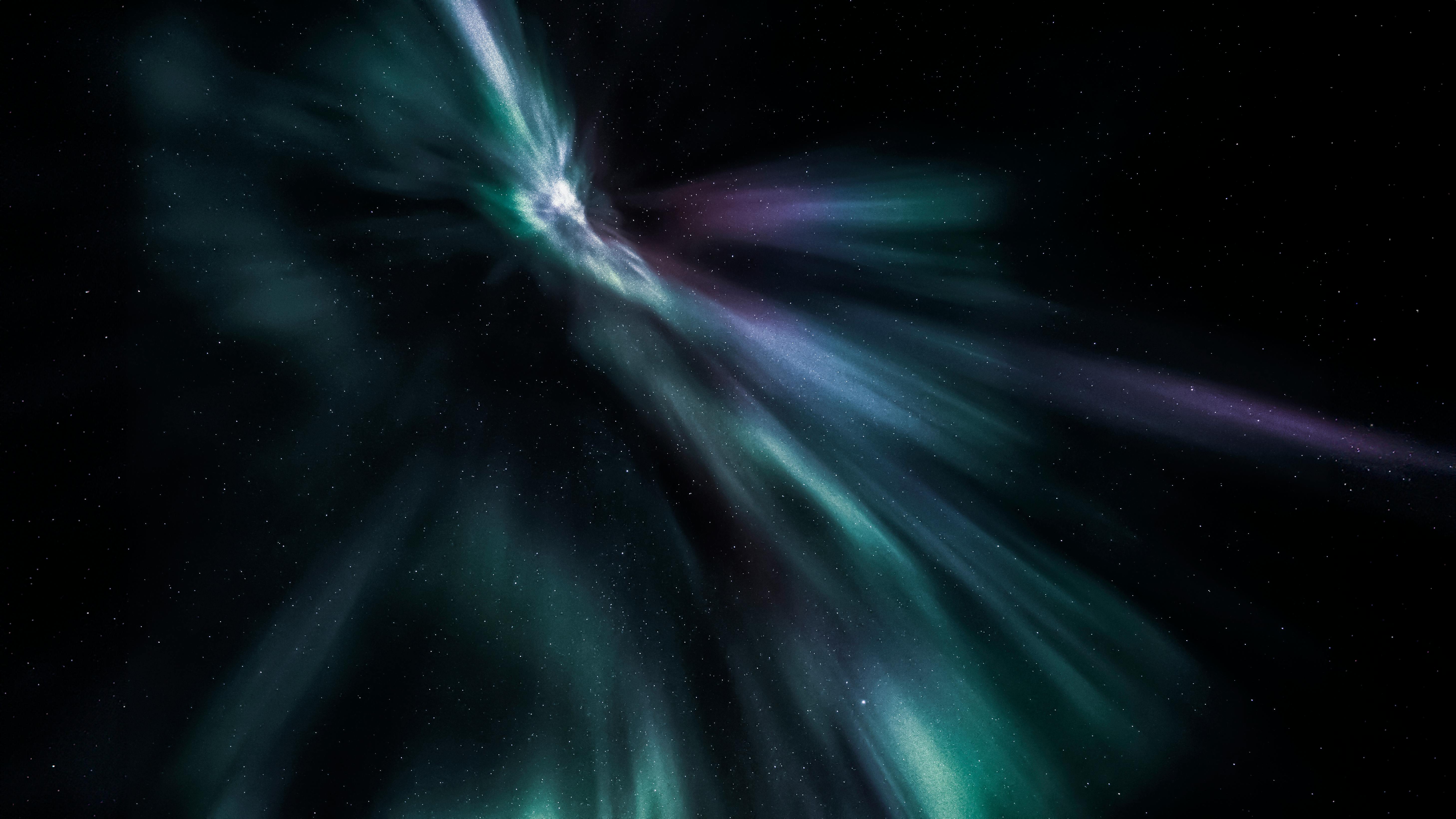 Vivid aurora borealis displays vibrant colors against a star-filled night sky, showcasing celestial beauty.