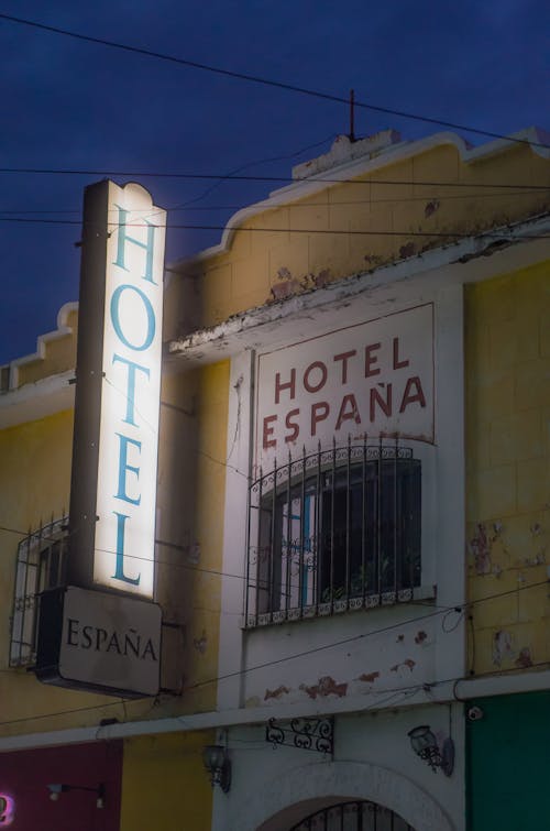 Exterior of an Old Hotel Building with an Illuminated Sign 