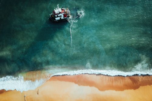 Free Drone shot of a sunken ship near the coast of Chukai, Terengganu, Malaysia. Stock Photo
