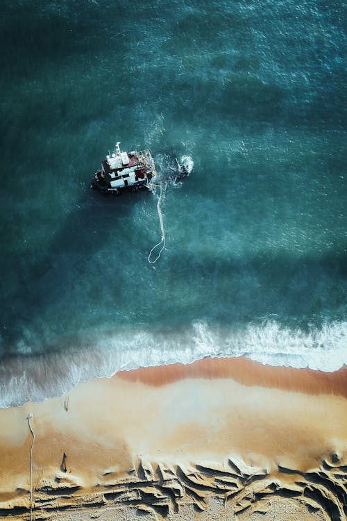 Free Aerial View of a Shipwreck near the Shore Stock Photo