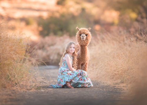 A Girl Posing with an Alpaca