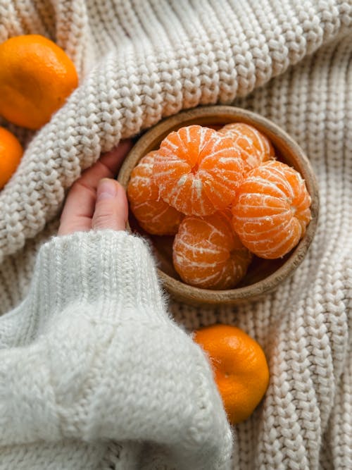 Close-up of Woman Holding a Bowl of Peeled Mandarins