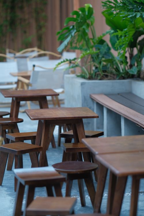 Free Elegant wooden tables and chairs in a modern outdoor restaurant setting Stock Photo