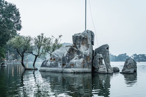 Free Beautiful rock formation and trees reflecting in a tranquil lake at Mount Abu, Rajasthan, India. Stock Photo