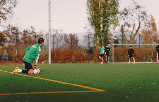 Men playing a casual soccer match on an outdoor field in Berlin during autumn.
