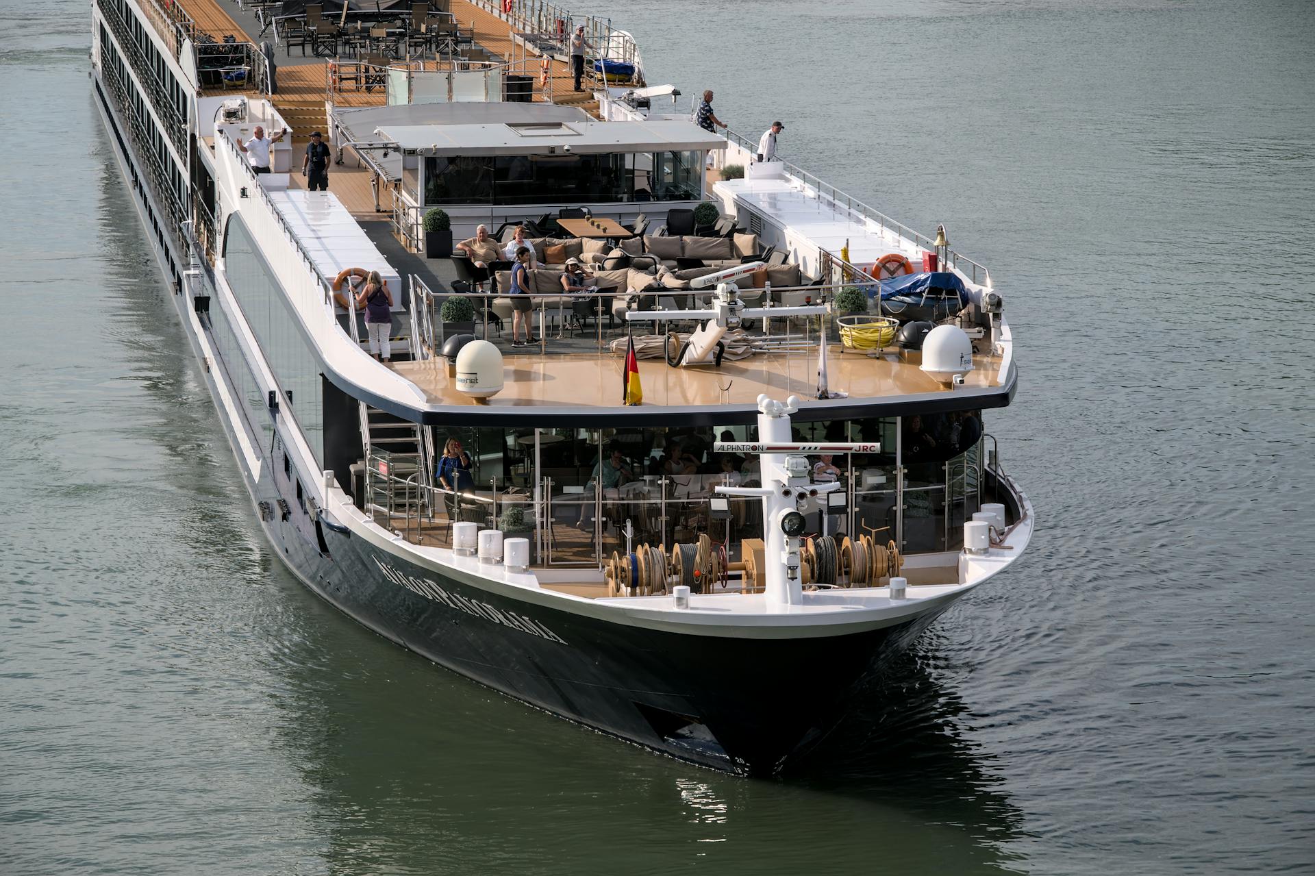 Elegant river cruise ship sailing peacefully with passengers enjoying the view.