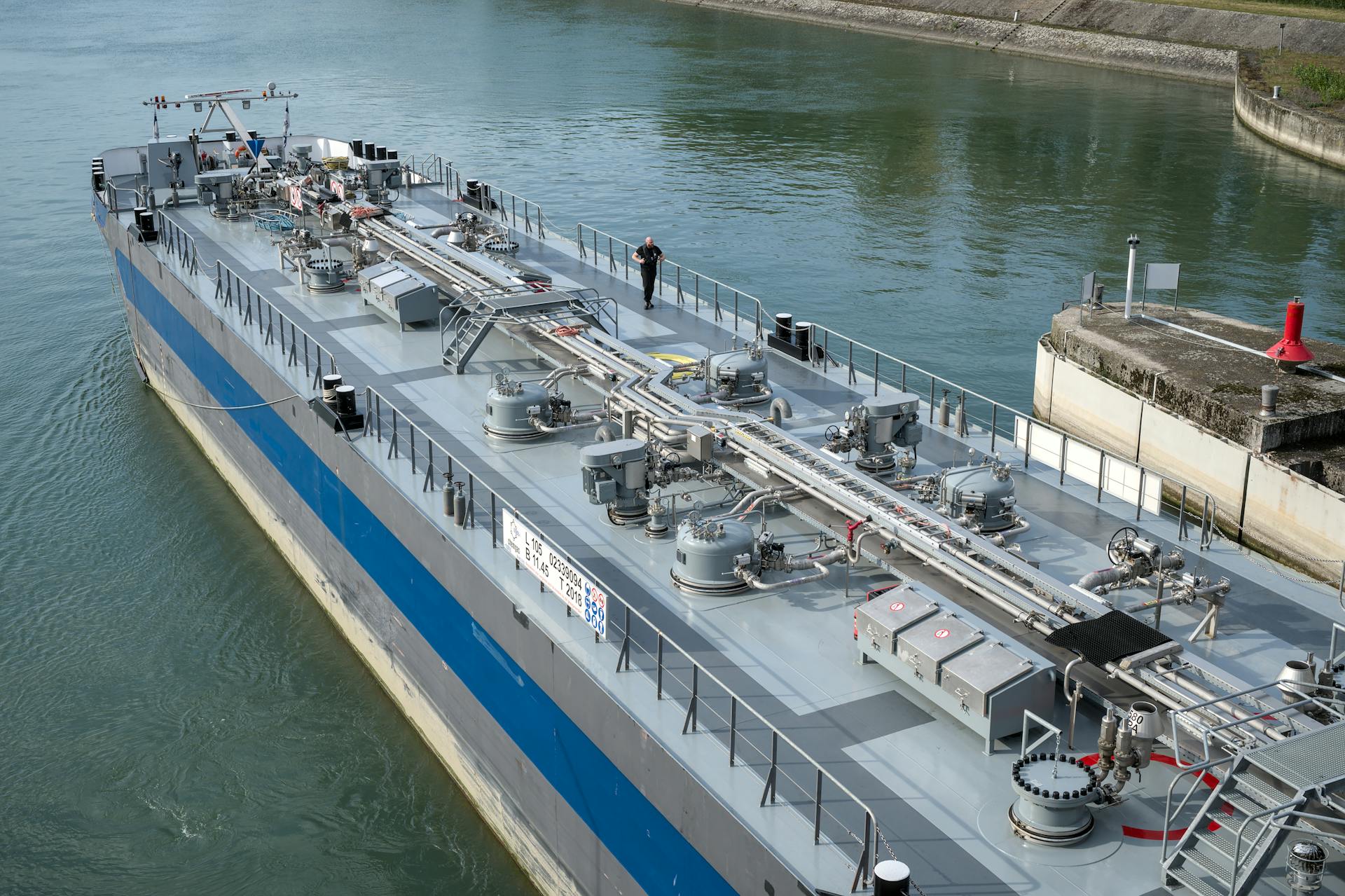 Aerial view of an industrial oil tanker docked at a harbor, showcasing modern maritime technology.