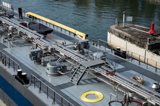 A detailed view of an industrial ship docked at a harbor with visible engineering components.