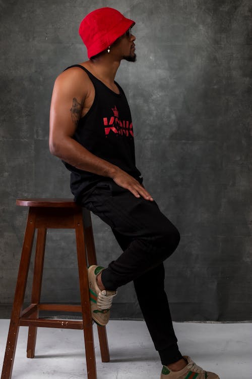 Model Posing in Tank Top and Red Hat