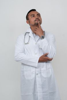 Portrait of a thoughtful young male doctor with a stethoscope, contemplating a diagnosis in Dhaka, Bangladesh.