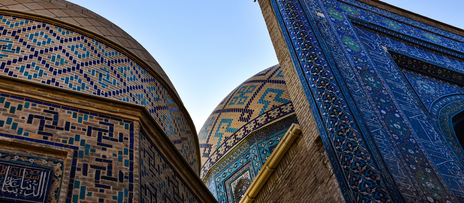 Explore the stunning mosaic patterns and domes of Shah-i-Zinda, a historic Islamic complex in Samarkand, Uzbekistan. — flights from Moscow to Samarkand