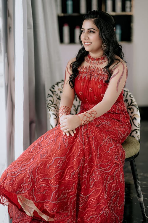 Woman in Red Dress Sitting on Chair