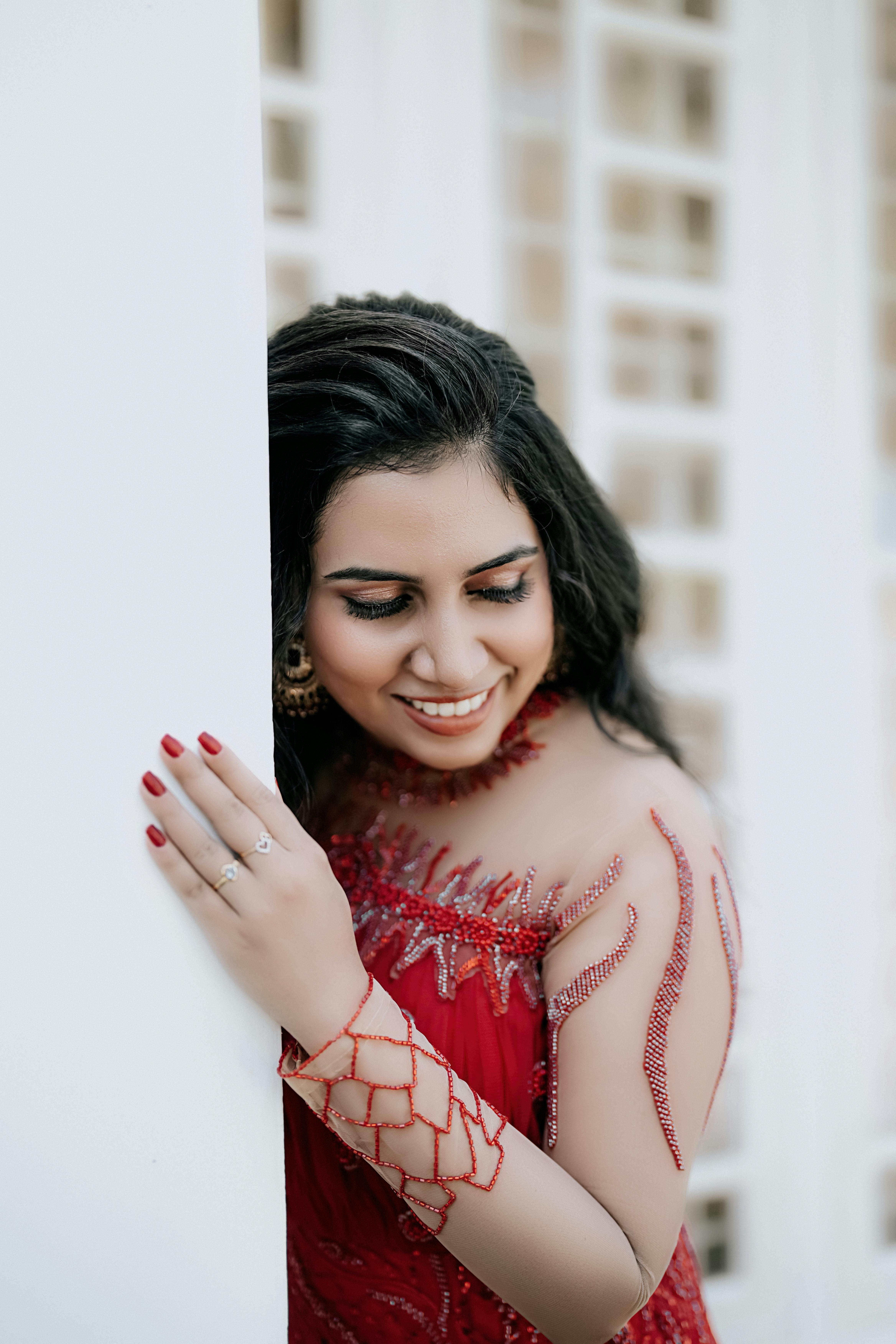 Free Photos - A Woman With Dark Hair Wearing A Stylish Blue Dress, Possibly  An Indian Saree, As She Poses Against A Yellow Wall. Her Expression And Pose  Create An Elegant And
