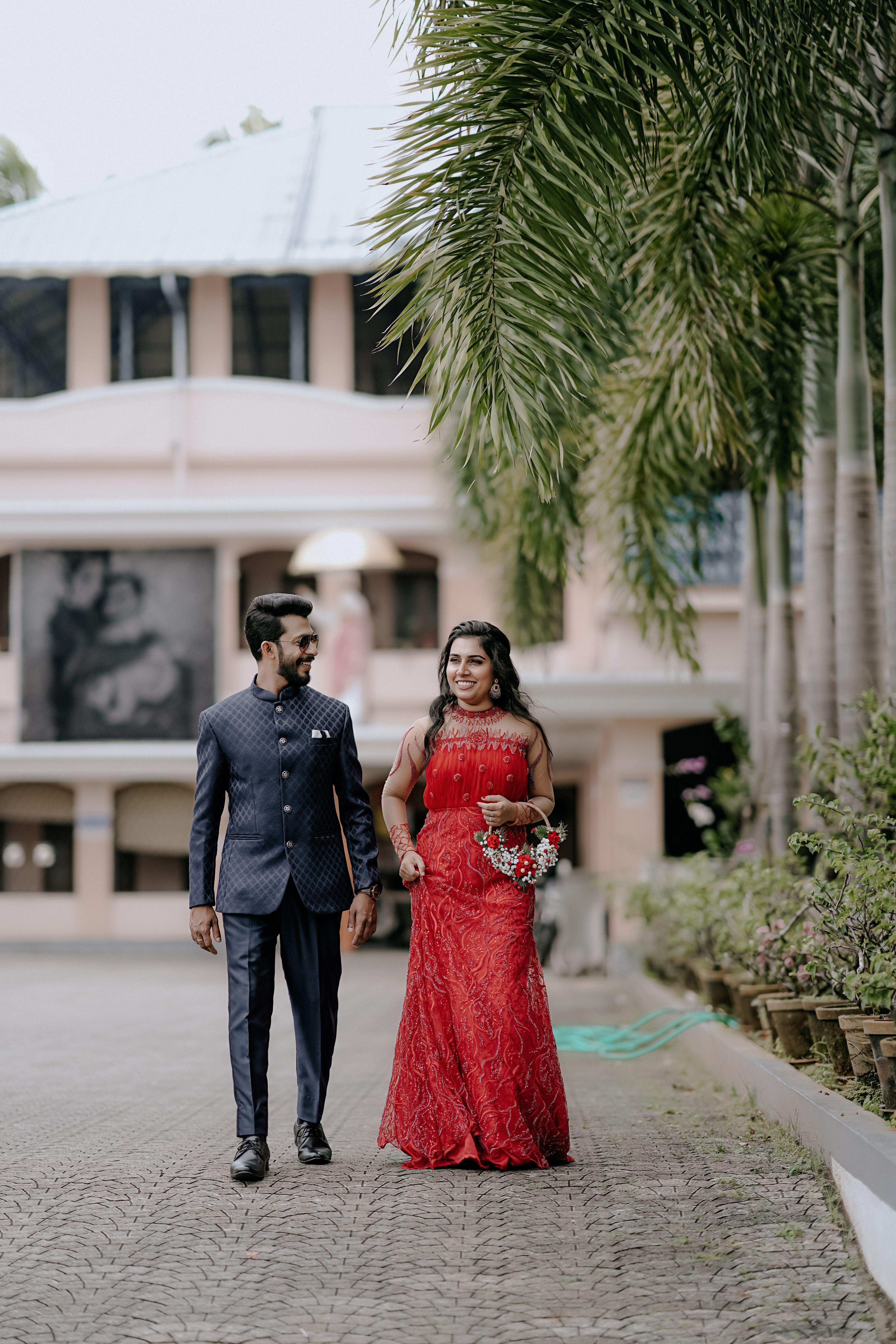 Traditional Wedding Couple Walking on Pavement · Free Stock Photo