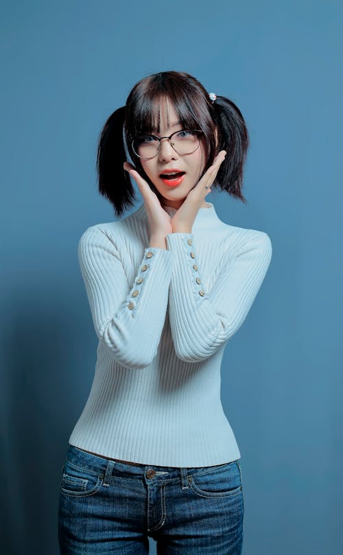Brunette Woman in White Sweater Posing in Studio