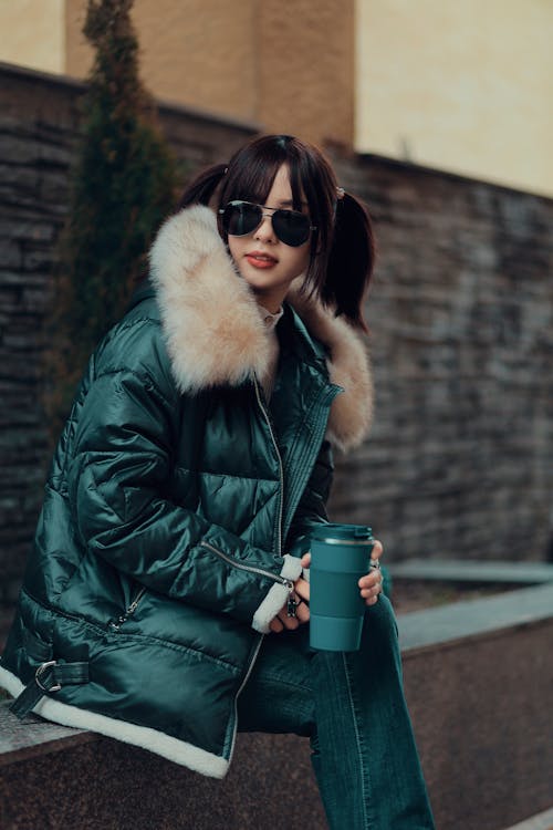 Woman Wearing Warm Coat on City Street with Coffee