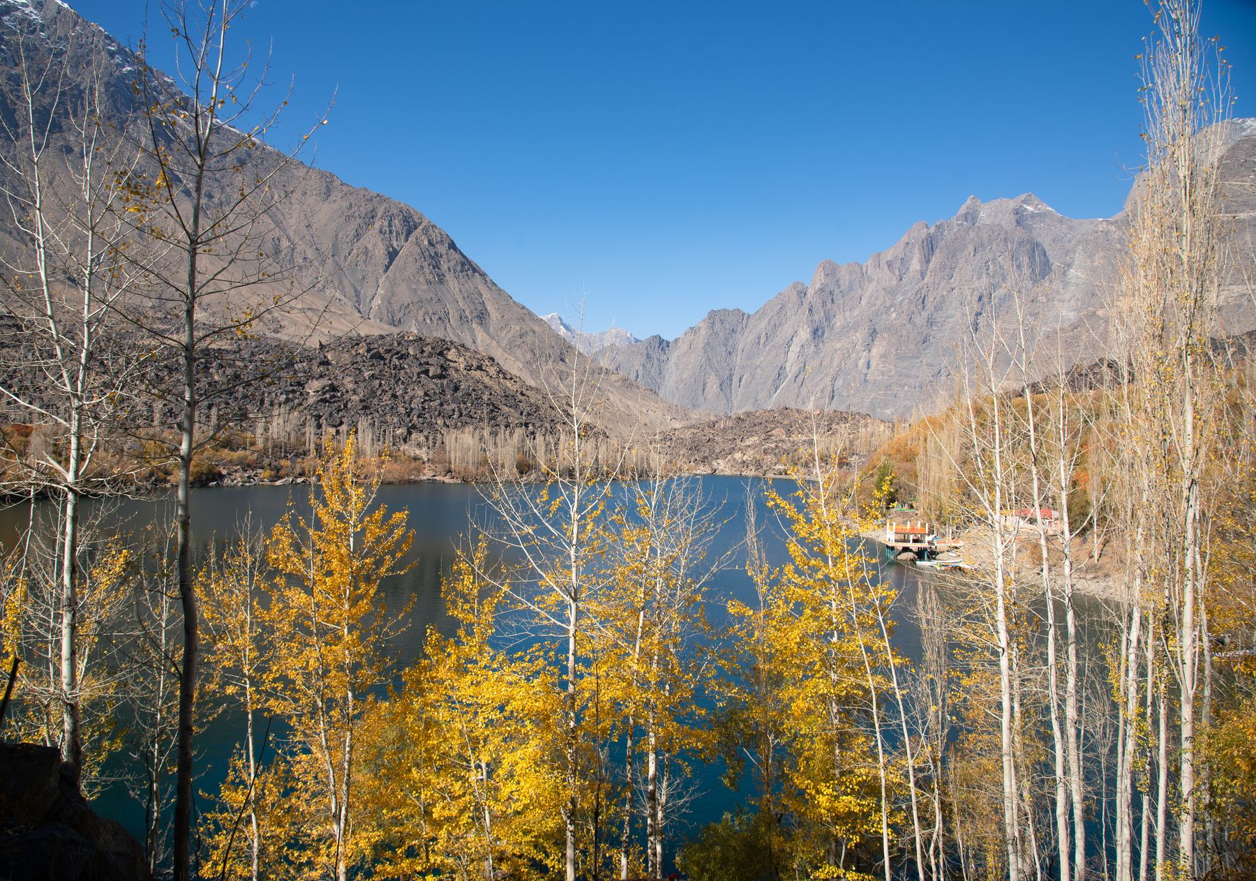 Captivating autumn scenery at Lower Kachura Lake with vibrant foliage and majestic mountains in Skardu, Pakistan.
