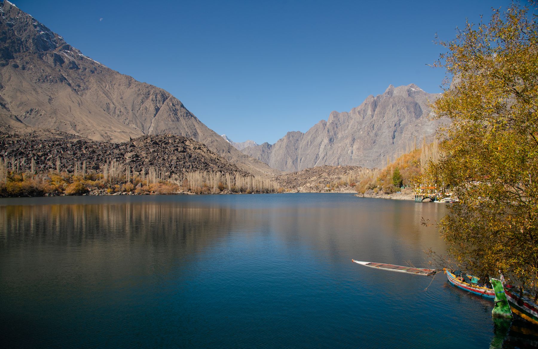 Scenic view of a tranquil lake with majestic mountains in Skardu, ideal for nature and travel imagery.