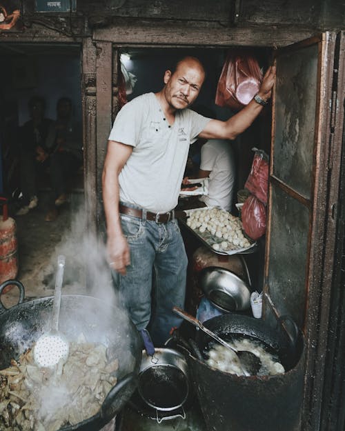 Free Man Preparing Street Food Stock Photo