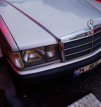 Detailed close-up of a classic Mercedes Benz hood and headlights, showcasing the vintage design.