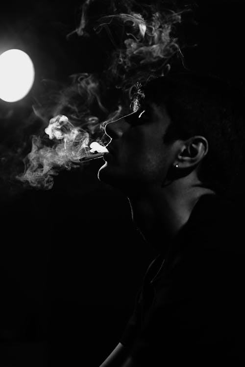 Abstract Black and White Photo of a Man with a Cigarette Smoke