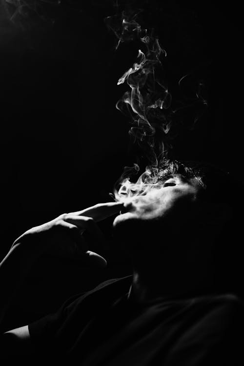Abstract Black and White Photo of a Man with a Cigarette Smoke