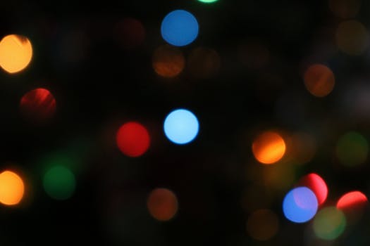 Colorful bokeh lights create a vivid and abstract background, perfect for festive themes.
