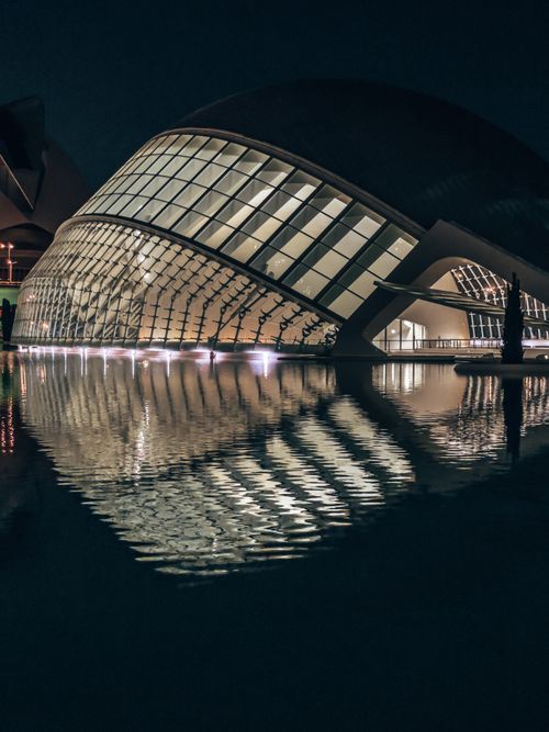 Free Modern architecture of Hemisfèric, Valencia, beautifully illuminated at night with reflection. Stock Photo