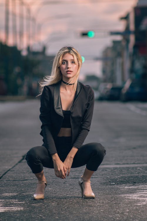 Young Slim Model in a Black Blazer and Pants in the Middle of the street