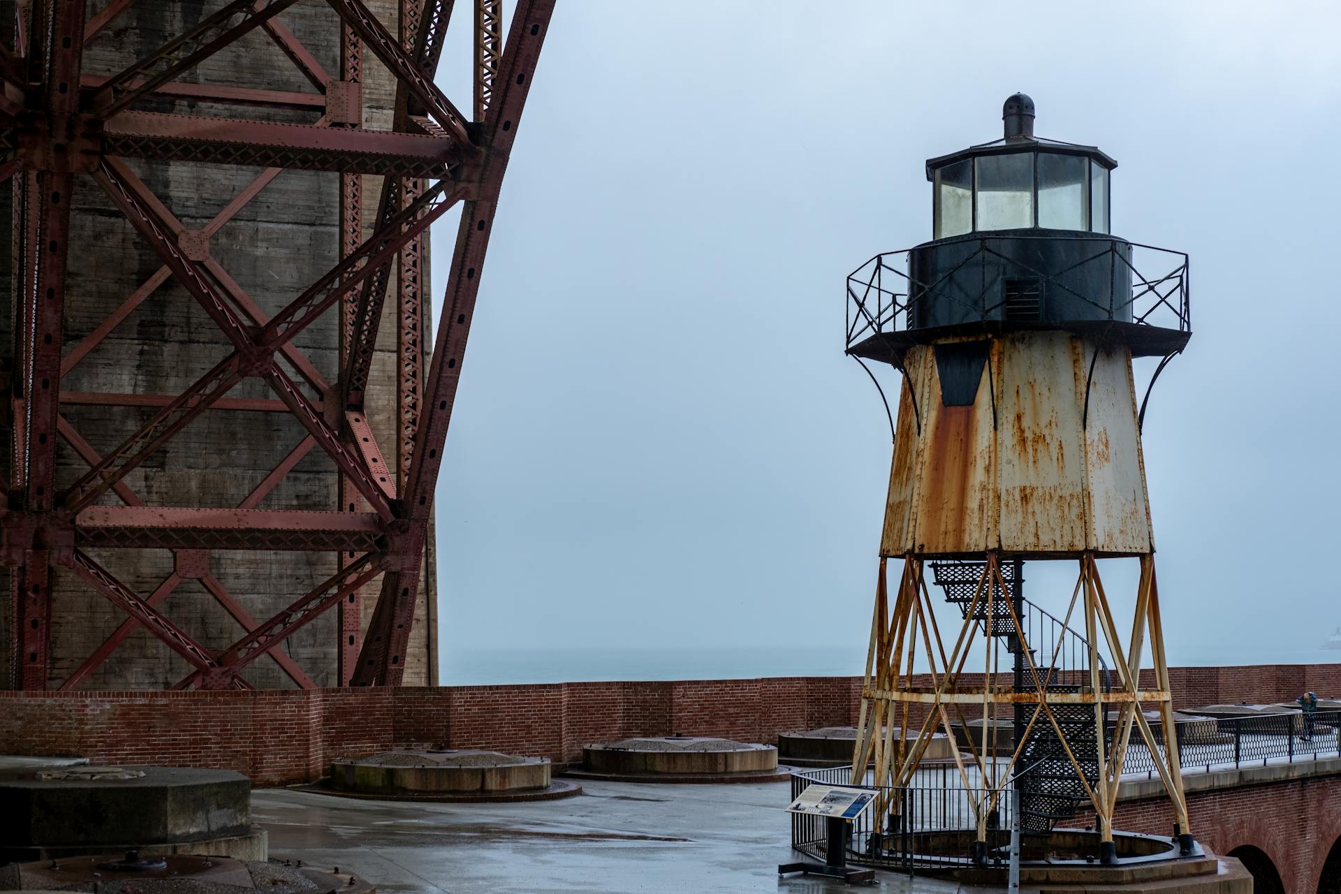 Rusty Fort Point Lighthouse beneath Golden Gate Bridge, San Francisco.