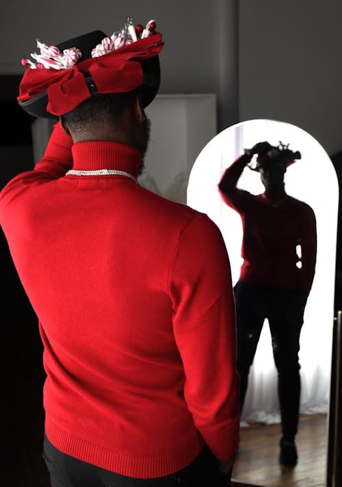 Man in Red Sweater Looking in the Mirror 