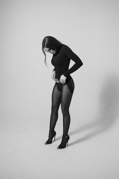 Model Posing in Bodysuit and Heels