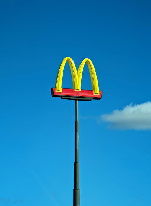 McDonalds Logo on a Post Against the Blue Sky