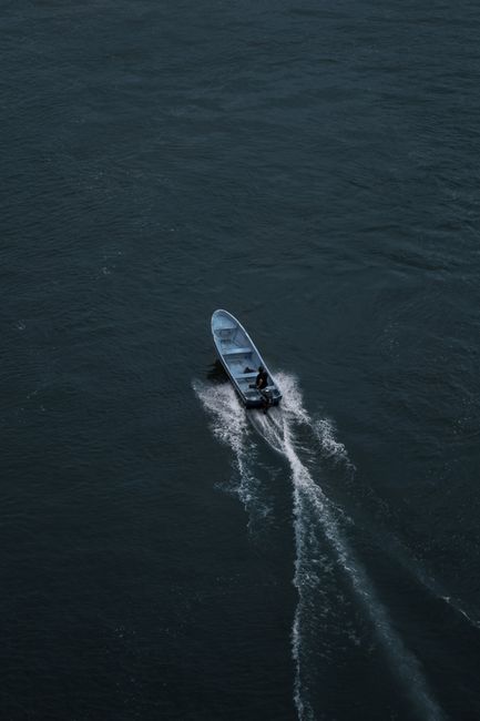 Drone shot of a motorboat creating a wake on Izabal's vast waters, Guatemala.